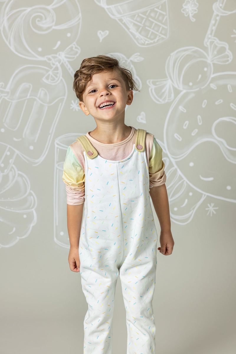 boy in sprinkle overalls and rainbow ombre top
