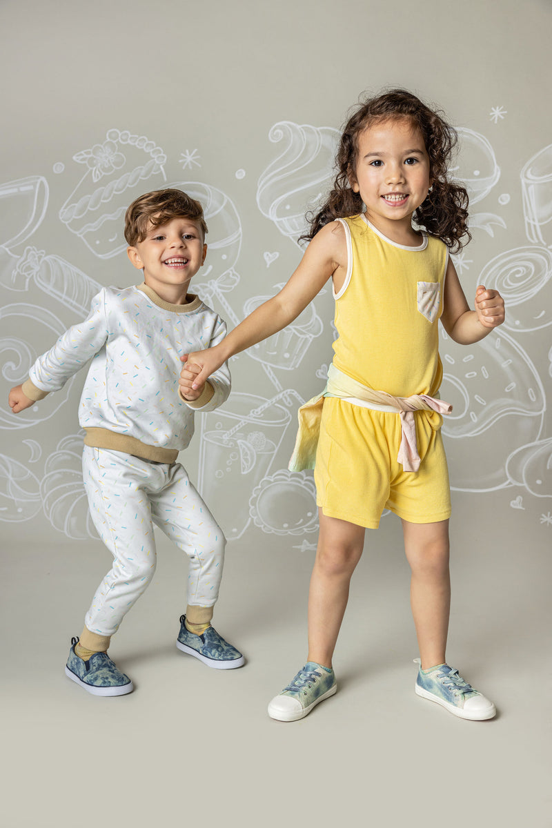 Boy in Sprinkle Sweat Set and girl in yellow ribbed set